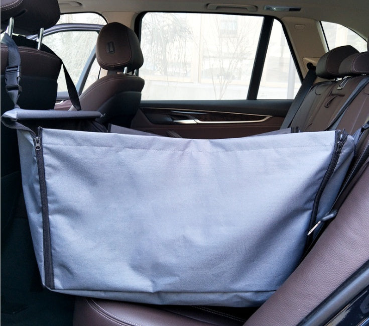 Gray waterproof dog car hammock installed securely across a vehicle back seat