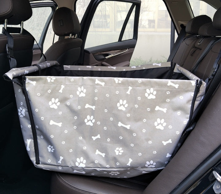Gray waterproof dog car hammock with paw and bone print installed on a back seat