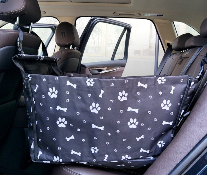 Black waterproof dog car hammock with paw and bone print installed on back seat