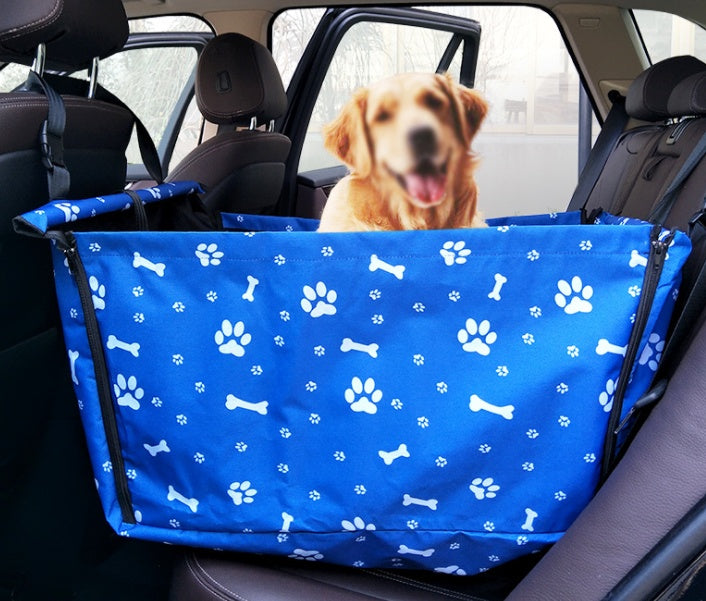 Dog riding in a blue waterproof car hammock on the back seat