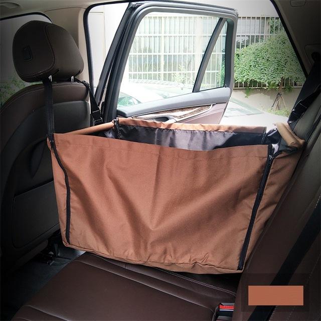 Brown waterproof dog car hammock installed on a vehicle back seat