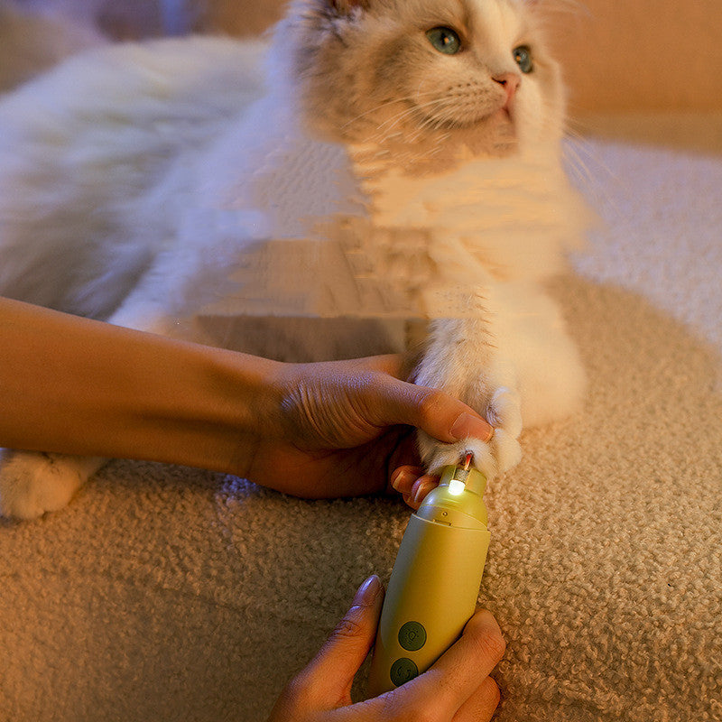 Rechargeable pet nail grinder being used to trim a cat's nails