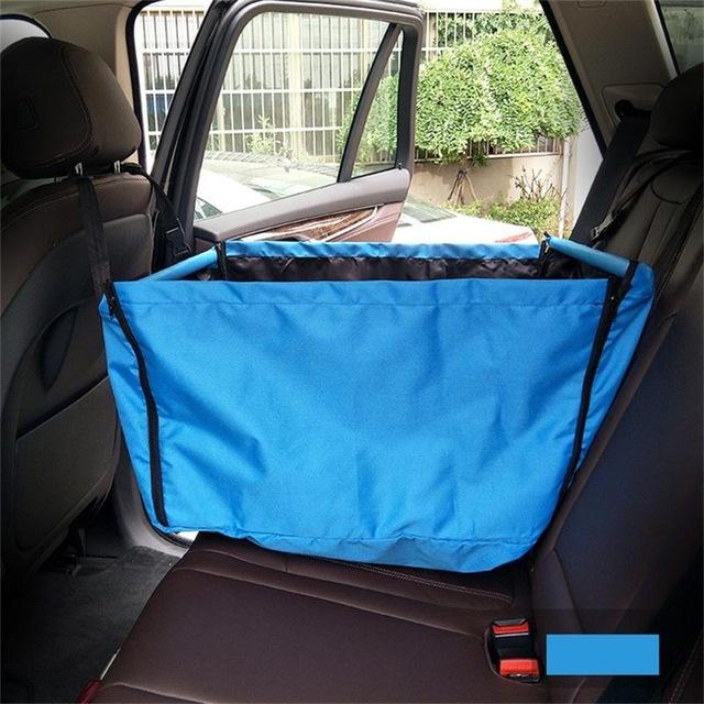 Blue waterproof dog car hammock installed on a vehicle back seat